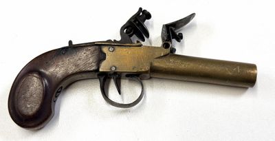 gros plan d'un pistolet sur une surface blanche