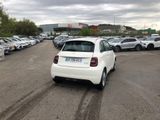 a white car parked in a parking lot next to other cars