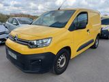a yellow van parked in a parking lot next to other cars