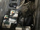 many electronic devices in a metal basket on the shelf