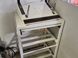 a table with a sewing machine on it in a room