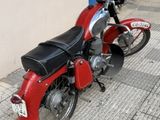 a red motorcycle parked on the side of the street