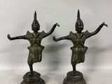 a pair of bronze statues of a man and a woman