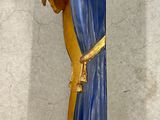 a blue and gold clock hanging on the wall