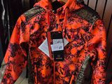 an orange and black jacket on display in a clothing store