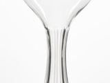 a wine glass sitting on a table with a white background