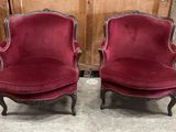 pair of red velvet chairs in the shape of a pair of chairs