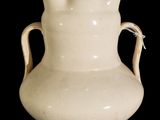 a white vase with handles on a black background