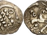 a silver coin with an image of a horse on it
