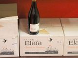 boxes and a bottle of wine sit on a shelf in a store