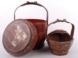 two wooden buckets with handles and handles sitting next to each other