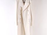 a white coat hanging on a hanger against a white wall