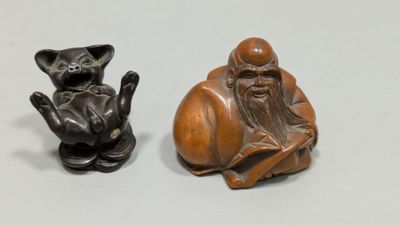 deux figurines représentant un homme et un chat posées sur une table