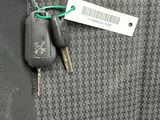 a car key with a tag attached to the back of a jacket