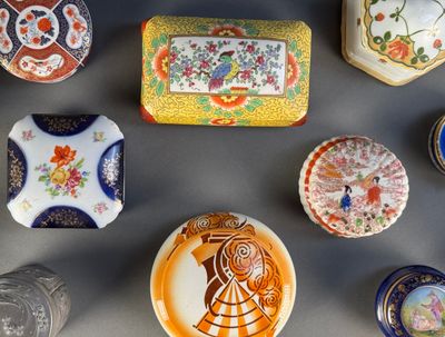 many different types of decorative boxes on the table