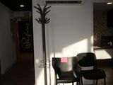 two chairs and a table in a room with a lamp