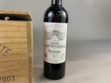 a bottle of wine sitting next to a wooden box