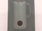 packaging of a green electric kettle sitting on top of a white table