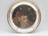 a silver plate with a picture of a dog in it