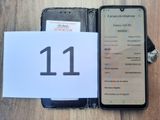 an image of a cell phone sitting on top of a table next to a paper