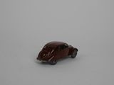 small toy car in the snow on a white surface