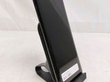 a cell phone that is on a stand on a table