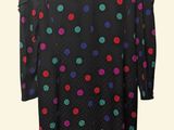 the back of a black dress with multicolored polka dots on it