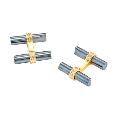 des boutons de manchette bicolores, or et argent, sur fond blanc