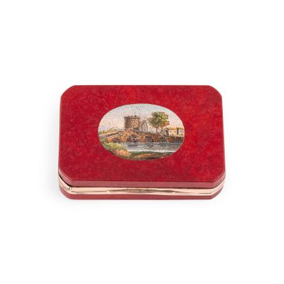 a small red box with a picture of a castle on it