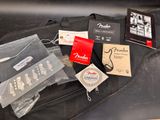 a guitar case that has a lot of items in it