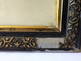 a picture of a black and gold frame on the wall