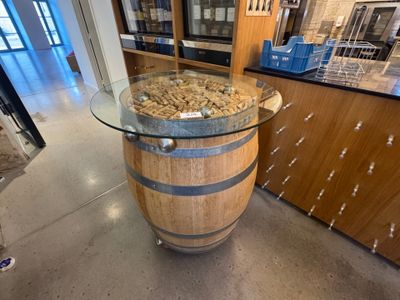 une table en verre sur laquelle est posé un tonneau en bois