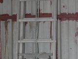 two ladders that are leaning against the wall