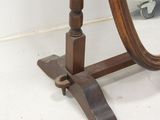 a mirror that is on a stand in a room