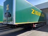 two semi trucks that are parked in a parking lot