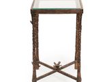 une petite table en verre avec un piètement en métal et un plateau en verre