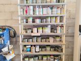 many cans of paint on the shelves in the garage