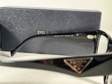 a pair of sunglasses sitting on a table next to a box