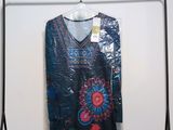 an image of a dress hanging on a rack in a room