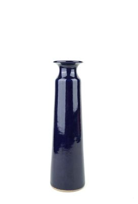 a blue vase that is sitting on a white surface