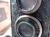 a close up of an old camera on a table
