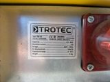 a close up of a red light on the side of a machine