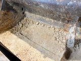 a close up of a piece of metal with dirt on it