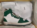 a pair of green and white sneakers in a box