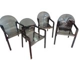 three clear plastic chairs sitting next to each other on a white surface