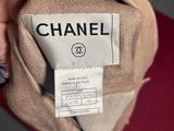 someone is holding a chanel label on a pair of shoes
