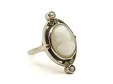 un gros plan d'une bague sertie d'une pierre blanche