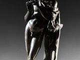 a bronze statue of a man and a woman sitting on a bench