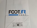 a close up of a white shopping bag with the foot r shop logo on it