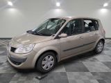 a picture of a small beige car parked in a garage